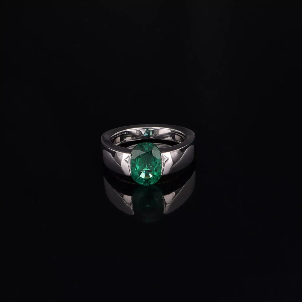 White gold ring with oval-cut emerald from Bollwerk Jewelers