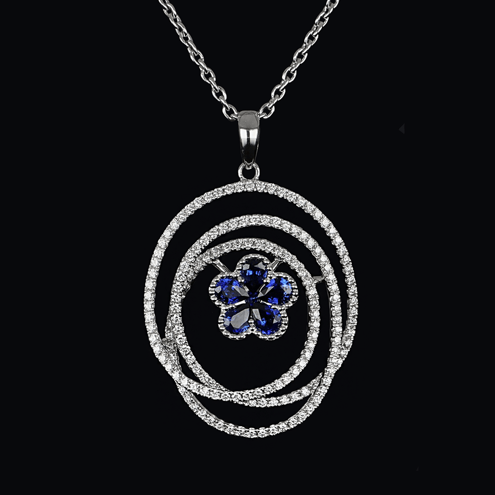 White gold pendant with white diamonds and blue sapphires